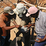 Inspecting a sapphire bearing rock at Winza.